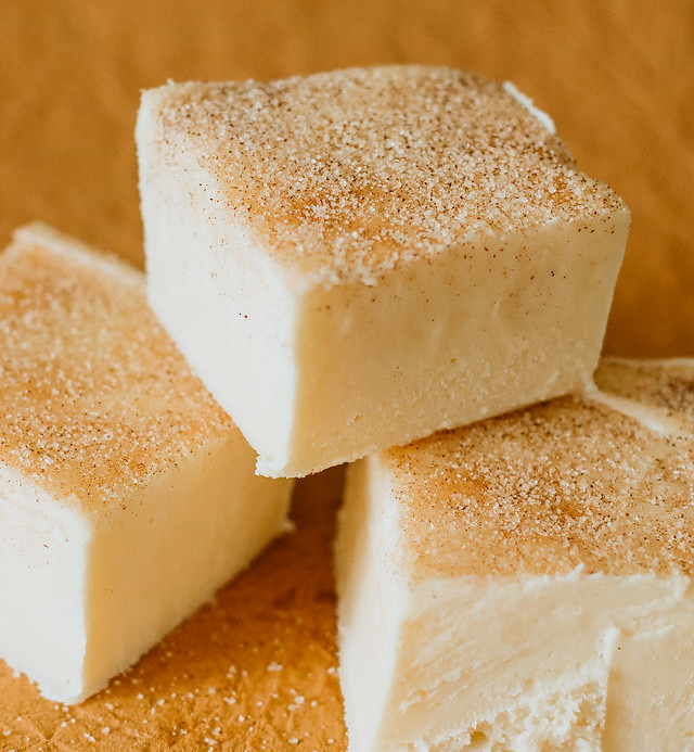 square version of cinnamon roll fudge stacked on itself