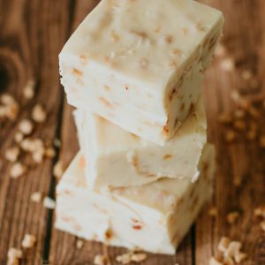 stack of health bar fudge with granola scattered on the table