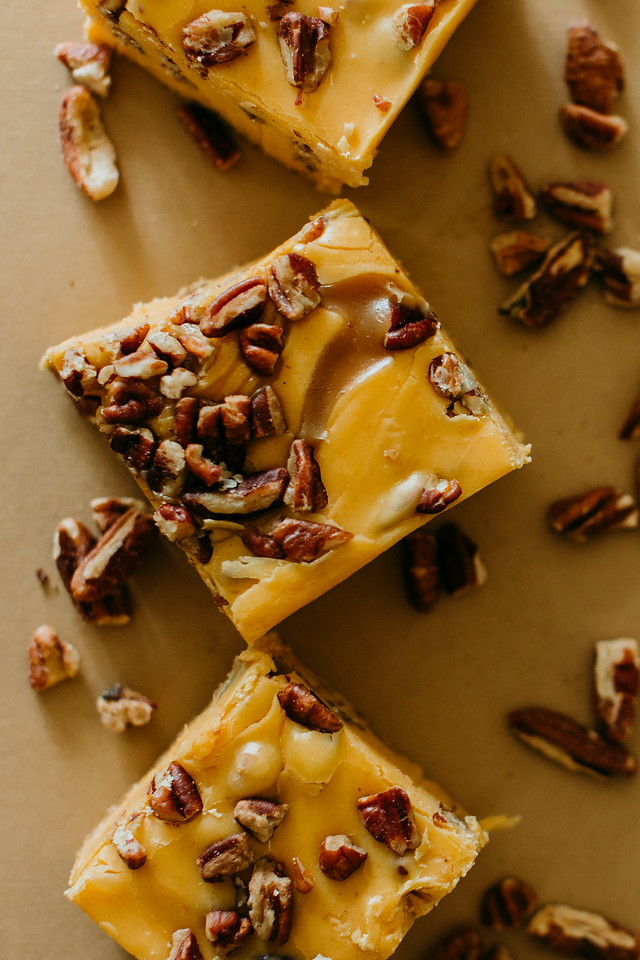 row of pumpkin praline fudge squares surrounded by nuts